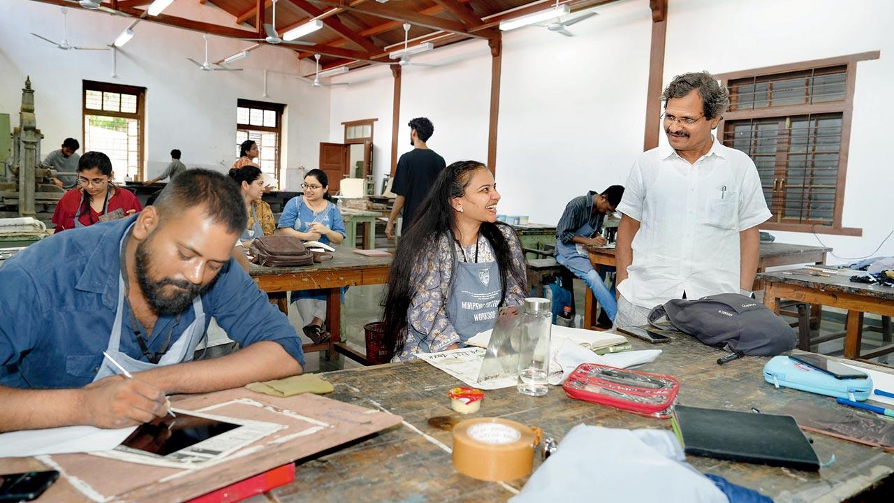 Students practise print-making at a session of the workshop