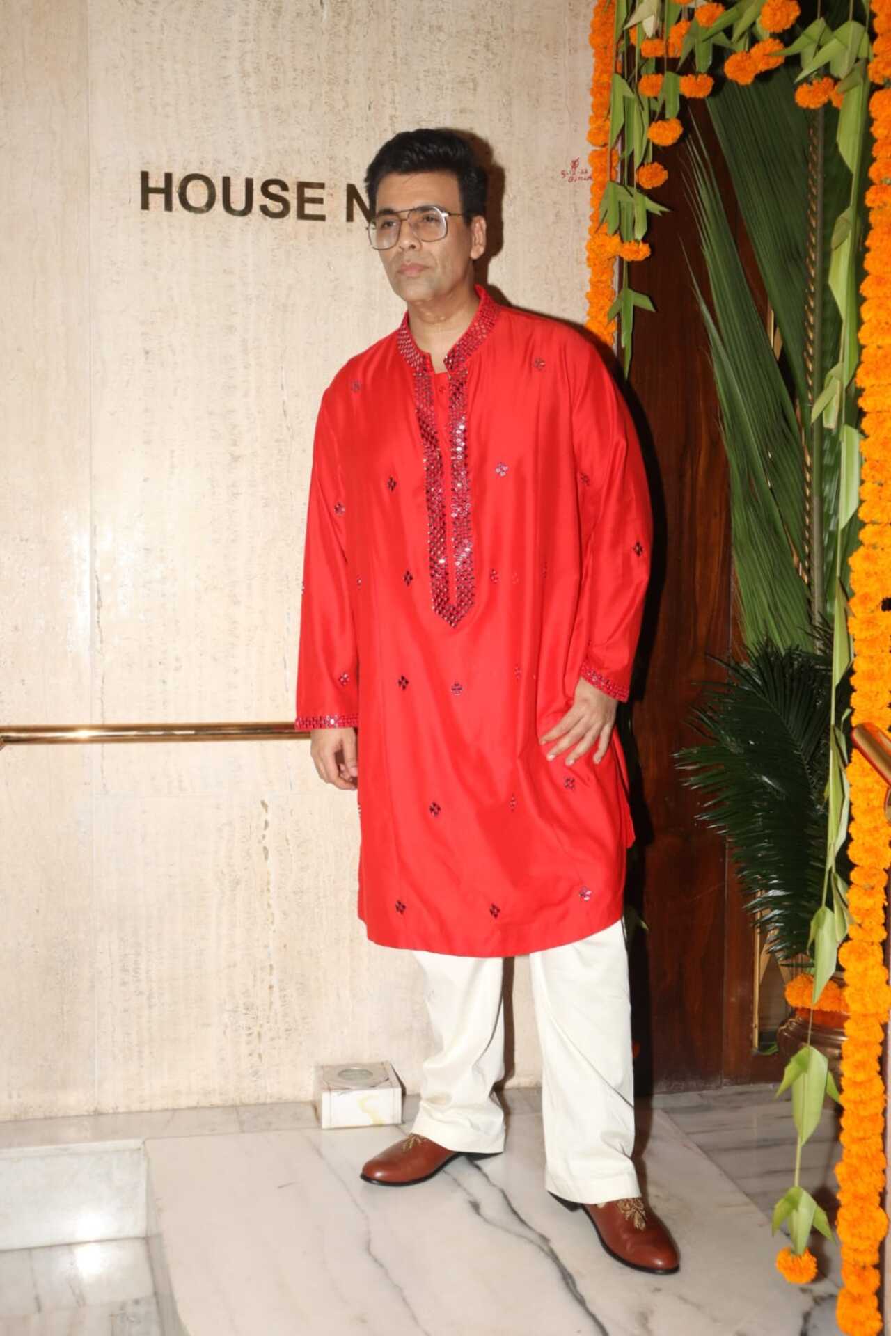 Karan Johar got clicked at Manish Malhotra's Ganesh Chaturthi celebration. The ace director wore a shimmery red kurta with white pyjama
