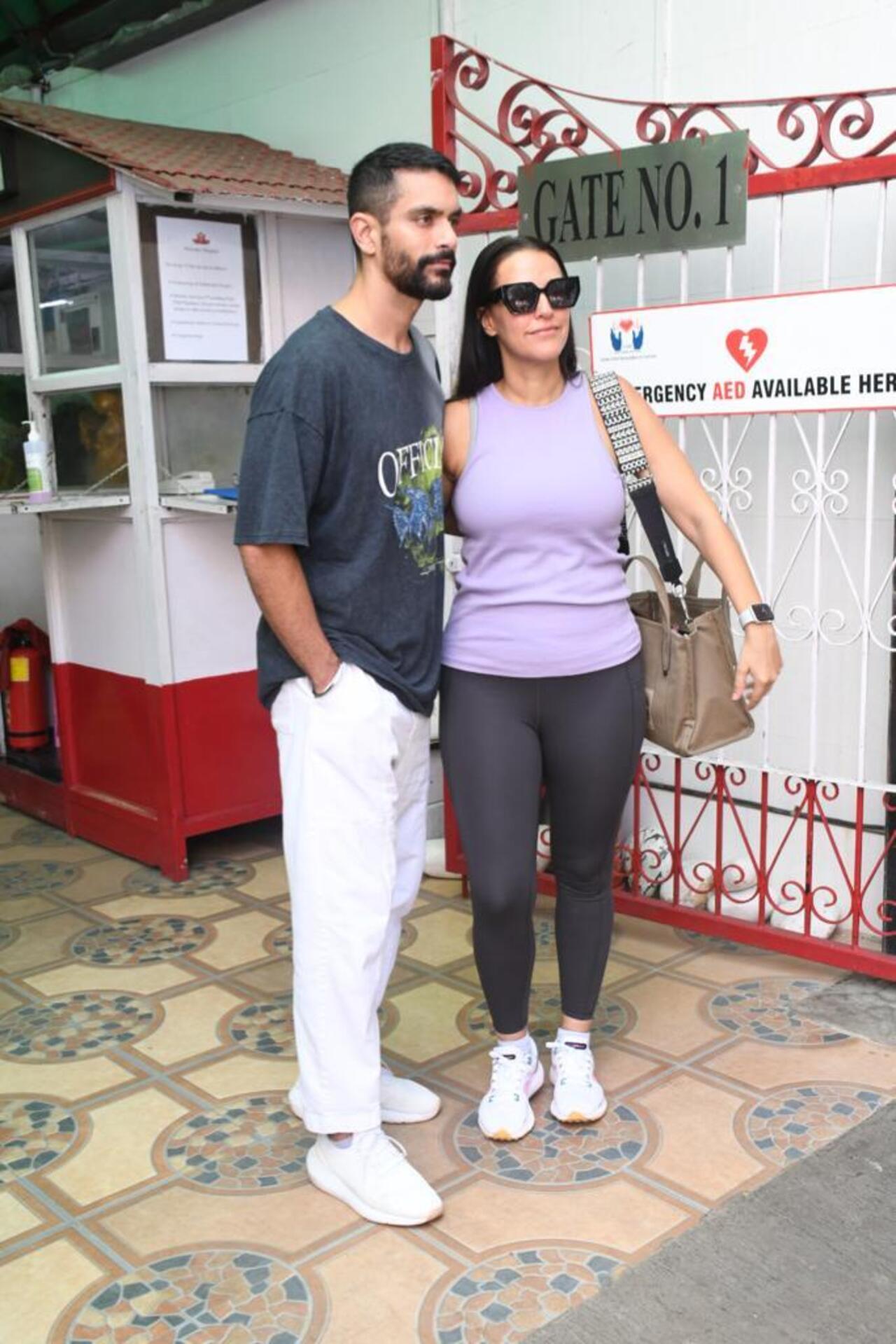 Neha Dhupia was photographed in a purple top paired with black jeans, while her husband, Angad, coordinated with her by wearing a blue T-shirt and white jeans