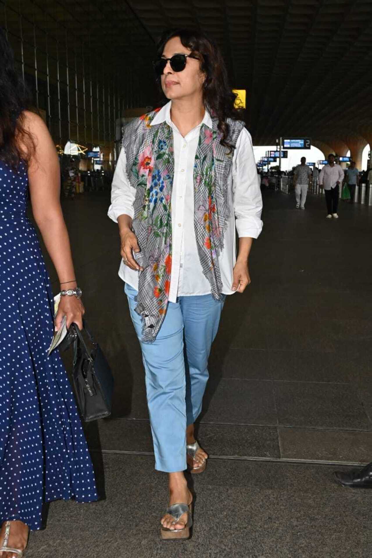 Juhi Chawla opted for a smart white shirt and blue jeans. The actress completed her airport look with putting a printed scarf around her neck