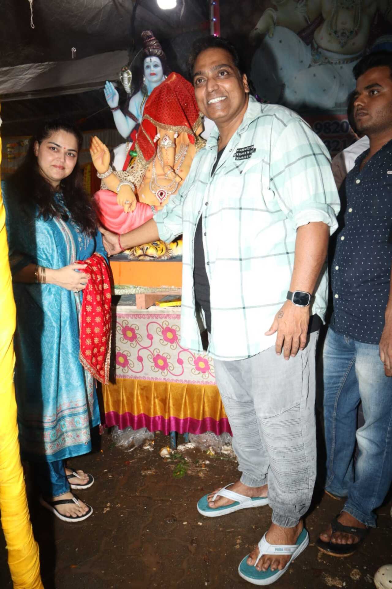 The choreographer poses with his wife in front of their Ganesha idol