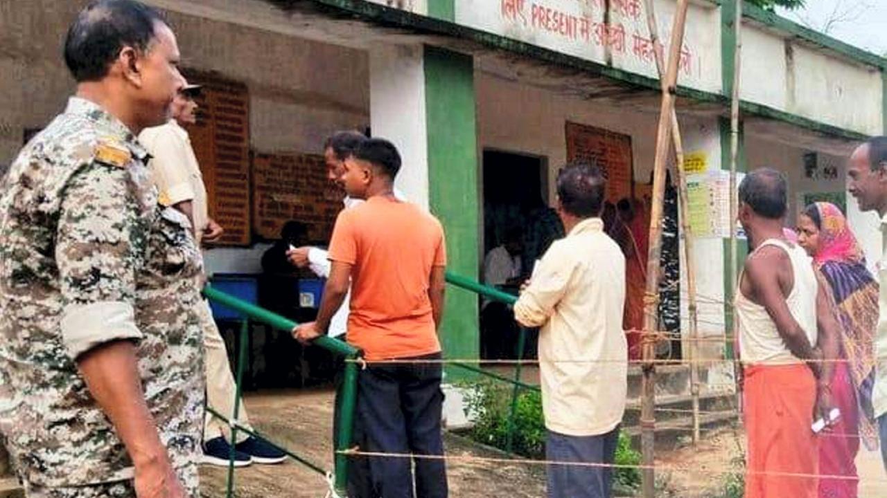 Voters arrive to cast their votes at a polling station during the by-elections to Dumri assembly seat in Jharkhand. Pics/PTI