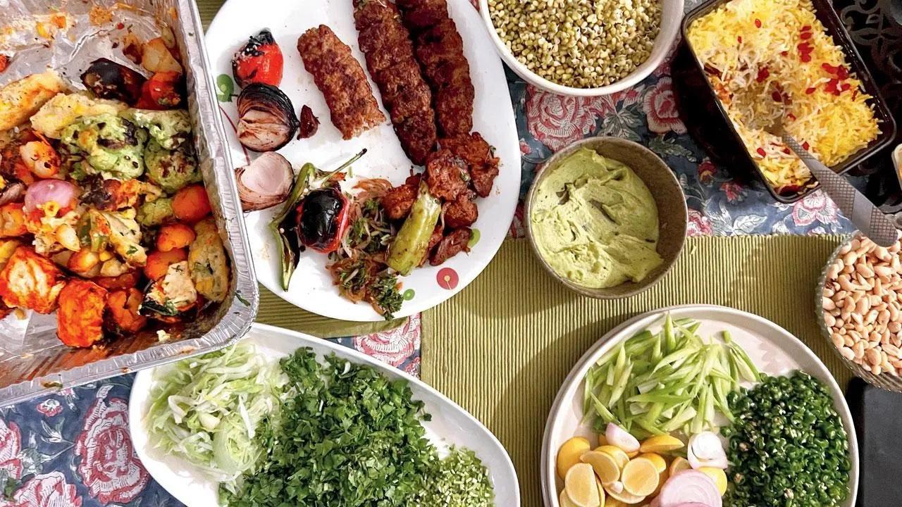 Peanuts; assorted vegetables; chicken koobideh; mutton koobideh and joojeh; mung beans; berry pulao; (centre) walnut chutney