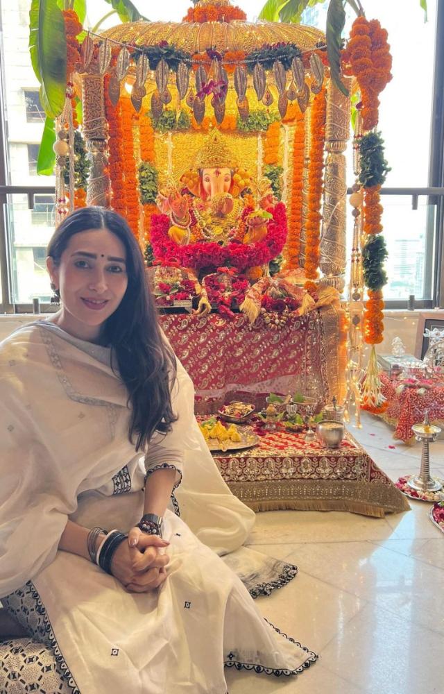 In one of the pictures, Karisma posed in front of the Ganpati idol wearing a stunning white kurta set
