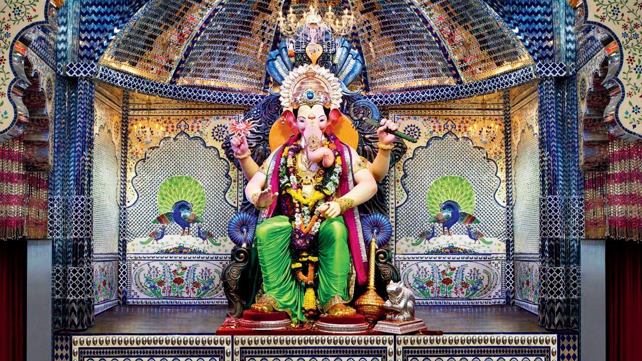 Bappa surrounded by mirror work and flanked by peacocks that Desai had said were inspired by Bollywood movie sets 