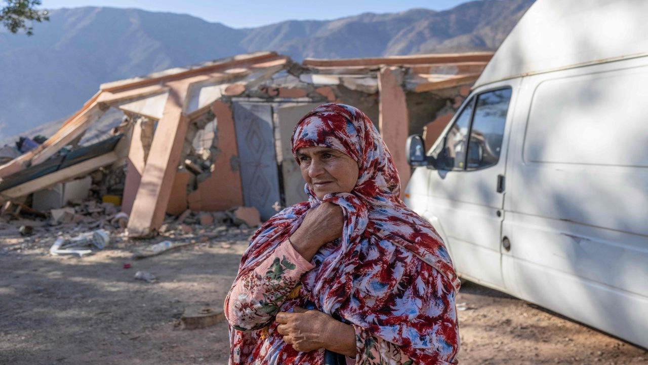 A woman waits as emergency personnel open a road to her village in the mountainous area of Tizi N'Test, in the Taroudant province, one of the most devastated in quake-hit Morocco. Medics treated a constant flow of casualties after Morocco's strongest-ever earthquake killed more than 2,800 people, but on September 12 hopes of finding more survivors under the rubble were fading.