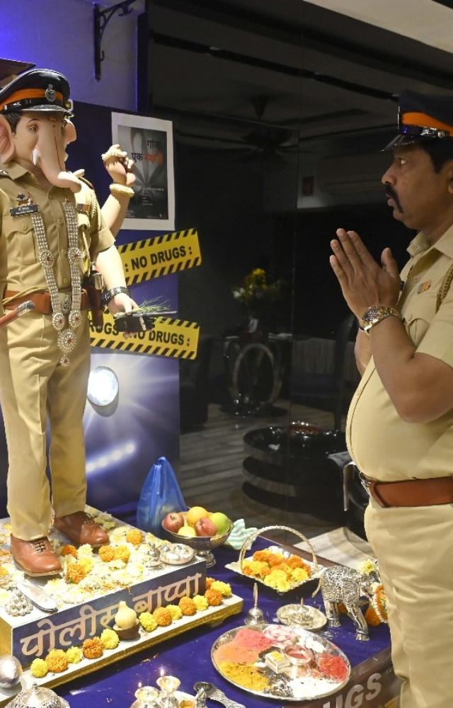 Ganesh idol dressed up like a police officer awares people against use of drugs during Ganeshotsav celebrations