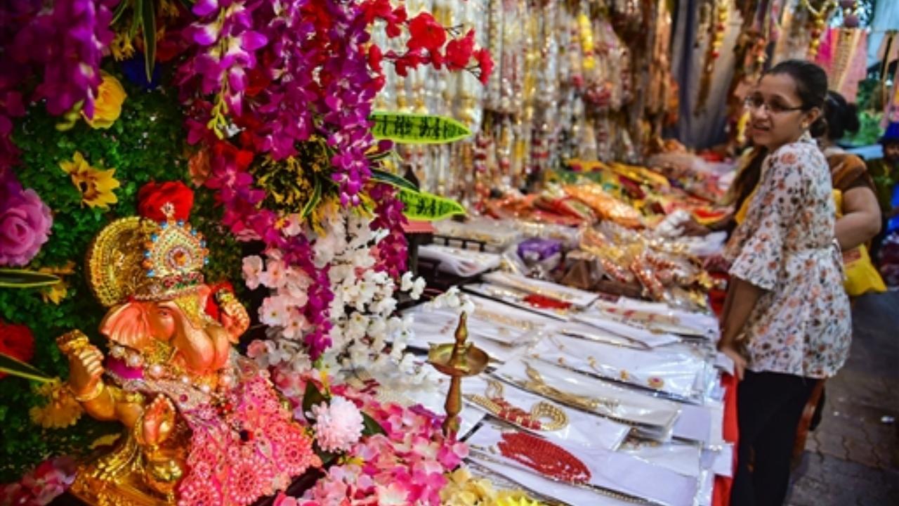 People shop for decorative items at APMC market ahead of 'Ganesh Chaturthi' festival, in Navi Mumbai