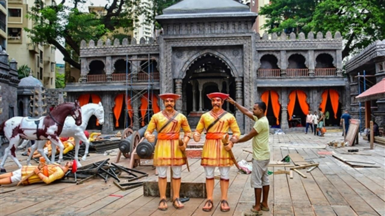 A worker stands near a newly-set up pandal, a replica of the Raigad fort, at Lalbaug Sarvajanik Utsav Mandal ahead of Ganesh Chaturthi festival