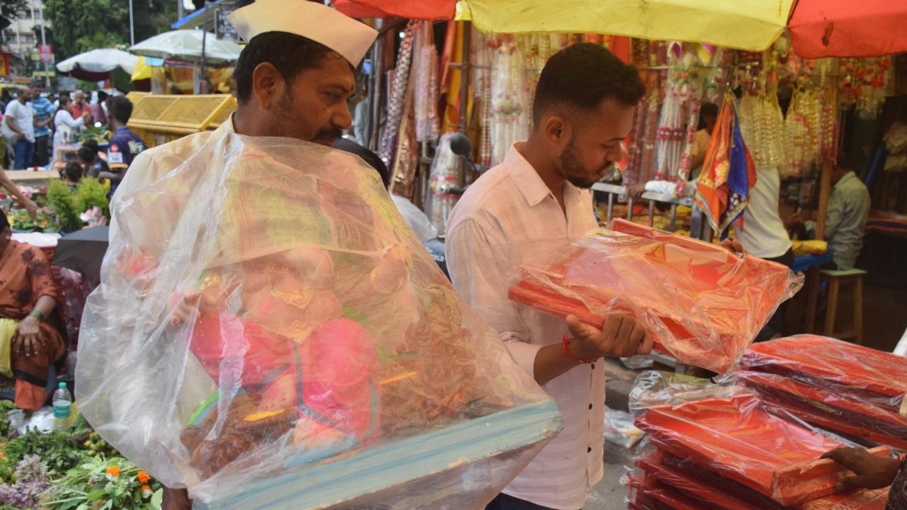A man buys lord Ganesha idol at Dadar market ahead of the festival. The Ganeshotsav festival will begin on Tuesday, September 19