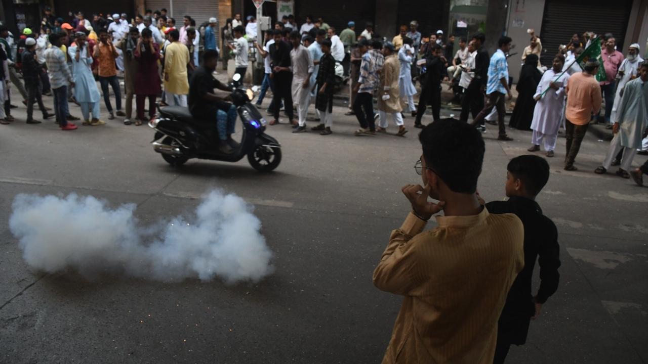 Youngsters bursting firecrackers on Mohammad Ali Road during the  Eid-e-Milad-un-Nabi procession
