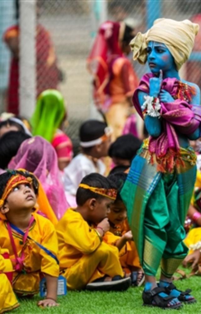 A student of Shivaji Shikshan Sanstha is seen dressed as Lord Krishna during the celebration of Dahi Handi festival ahead of Krishna Janmashtami, in Mumbai