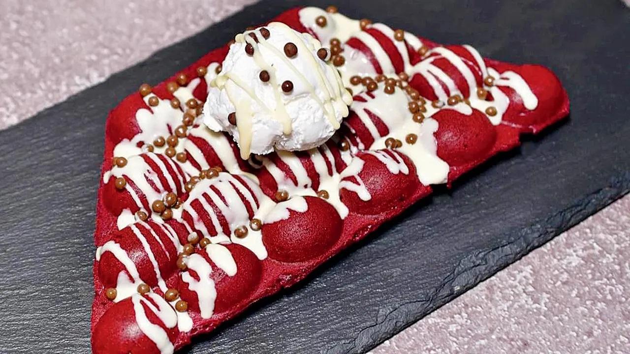 Bubble waffles, is a variation of the good old waffles and is a bit crunchier. The red velvet bubble waffle has dollops of white chocolate, milk and white chips; and is topped with two scoops of vanilla ice cream, and garnished with milk and white chocolate and chocolate chips. Dessert Cloud At CG Road, next to Raj Restaurant, opposite Hira Stores, Chembur. Call 7977695453Cost Rs 230 (full size)