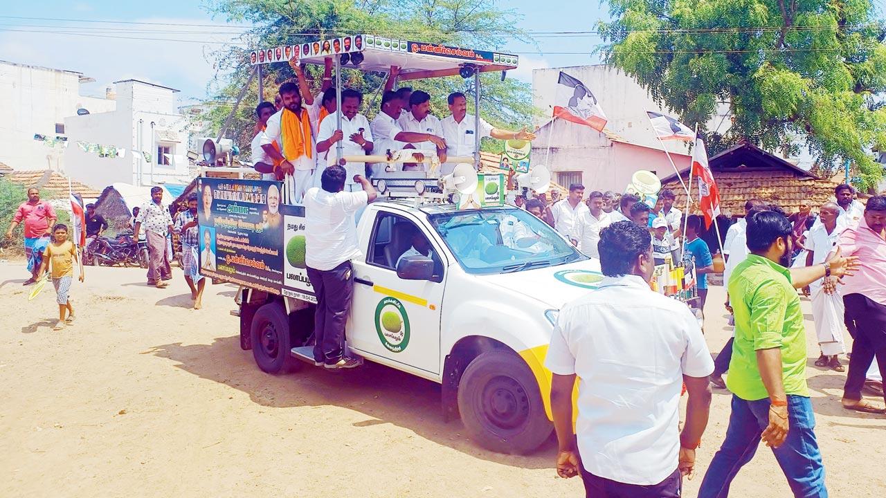 NDA candidate O Panneerselvam arrives at Keelathuval village to seek votes from the Thevar community.