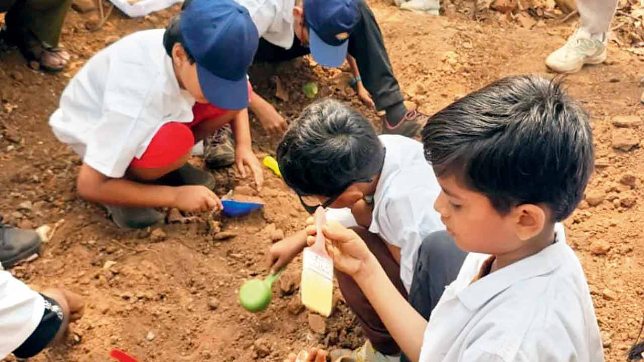 Children examine a fossil at the site