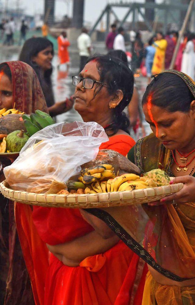 Devotees perform rituals on the banks of the river Brahmaputra during the ` Chaiti Chhath Puja` in Guwahati on Sunday. (ANI Photo)
