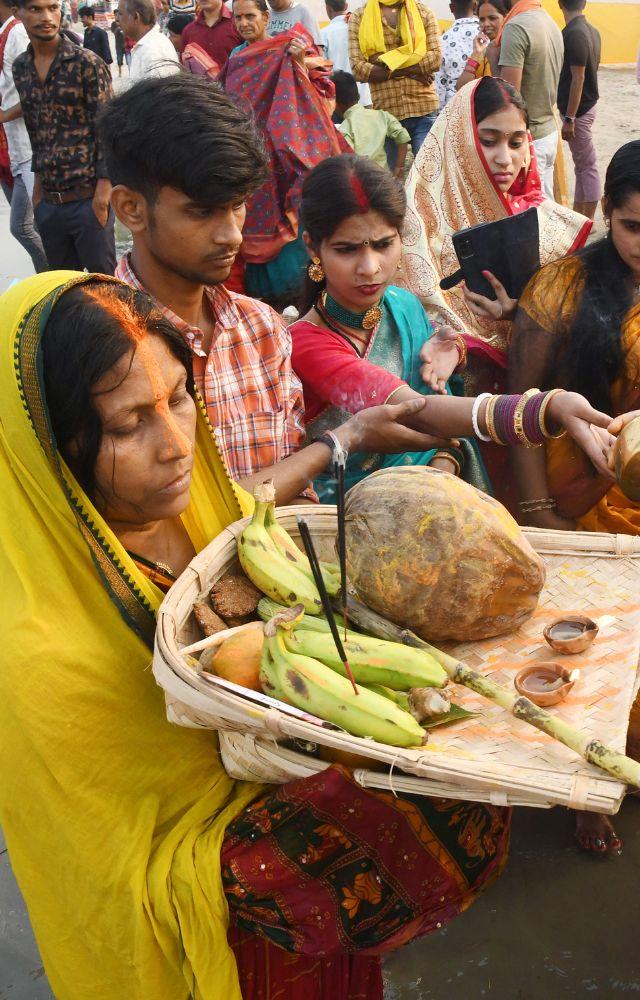 A devotee performing a ritual on the banks of Ganga river on the occasion of `Chaiti Chhath festival`, in Patna on Sunday. (ANI Photo)
