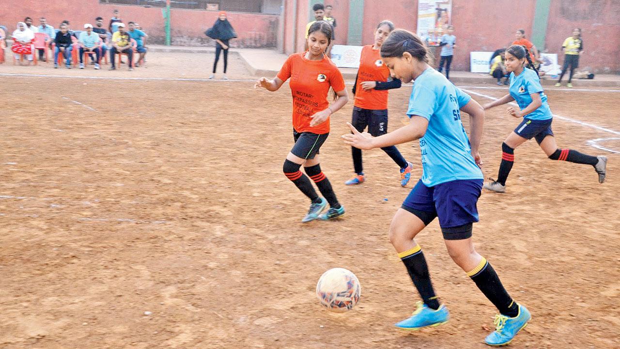 A girl dribbles past the opponents  during a match in the 2023 tournament