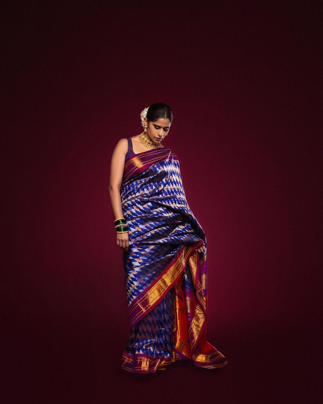 Sai Tamhankar consistently delights her fans with her impeccable fashion sense, particularly in traditional wear. In this captivating look, Sai donned a stunning blue saree with a broad golden and purple border, radiating timeless charm