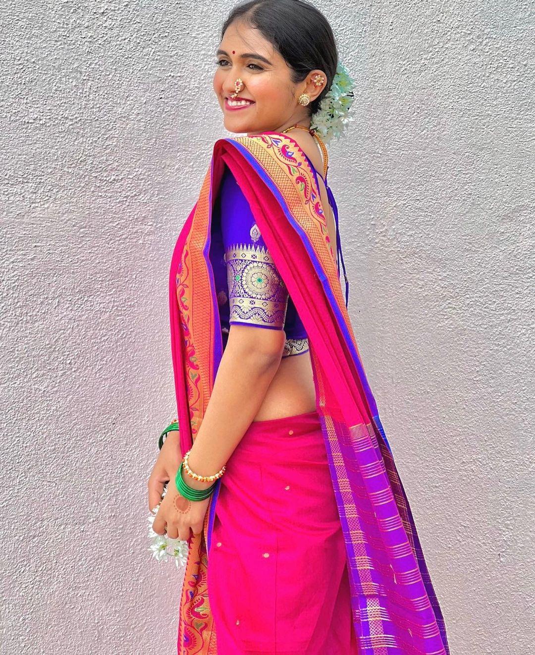 The actress paired her pink saree with a contrasting blue blouse. She wore stunning intricate golden jewellery, enhancing her look. To maintain the authentic traditional look, she tied her hair in a chic bun and decorated it with a stunning gajra