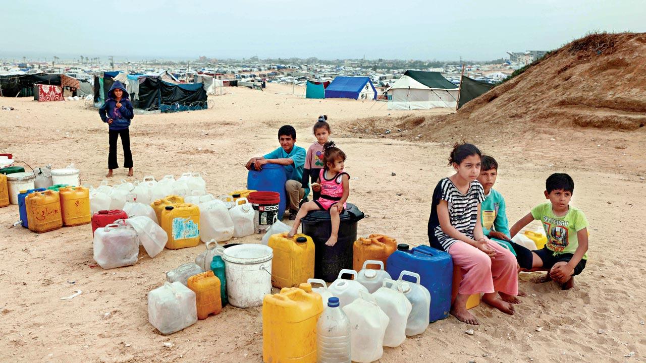 Displaced Palestinian children wait for water supply in Rafah. Pic/AFP