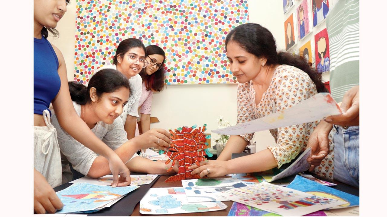 Monitoring and evaluation manager Tanushree Patel (right) chooses artworks to be put up at End of Year Exhibition 4.0. Pic/Anurag Ahire