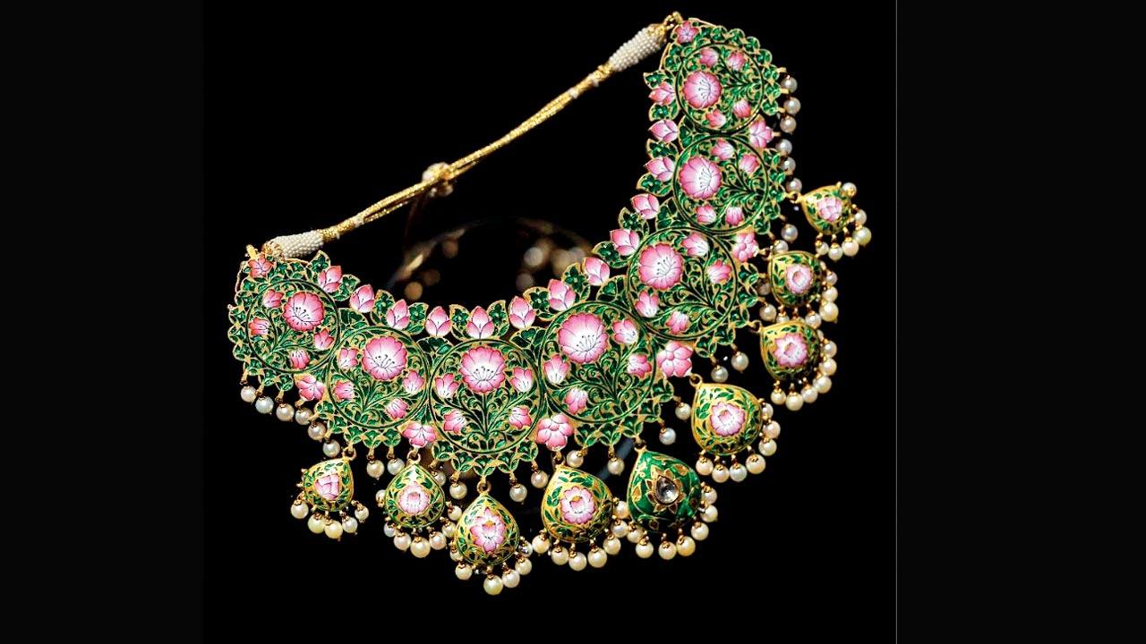 A necklace showcasing champlevé technique where the jewellery’s metal surface is engraved, creating troughs and channels which are filled with powdered enamel and then fired. The piece is intricately embellished with Gulabi Meenakari to give the lotus or padma motif emphasis, together with a string of South Sea pearls giving the adorer a synaesthetic feeling