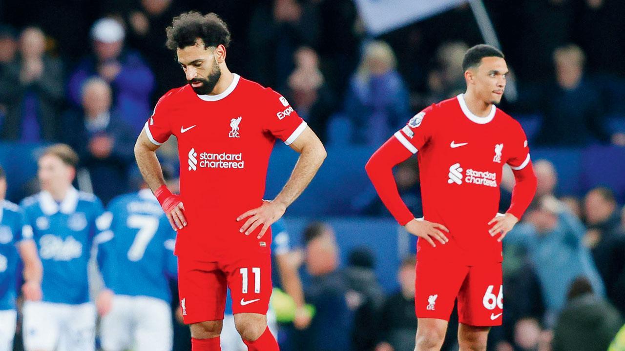 Liverpool’s Mohd Salah (left) and Trent Alexander-Arnold wear a dejected look during their match v Everton on Wednesday. Pic/Getty Images