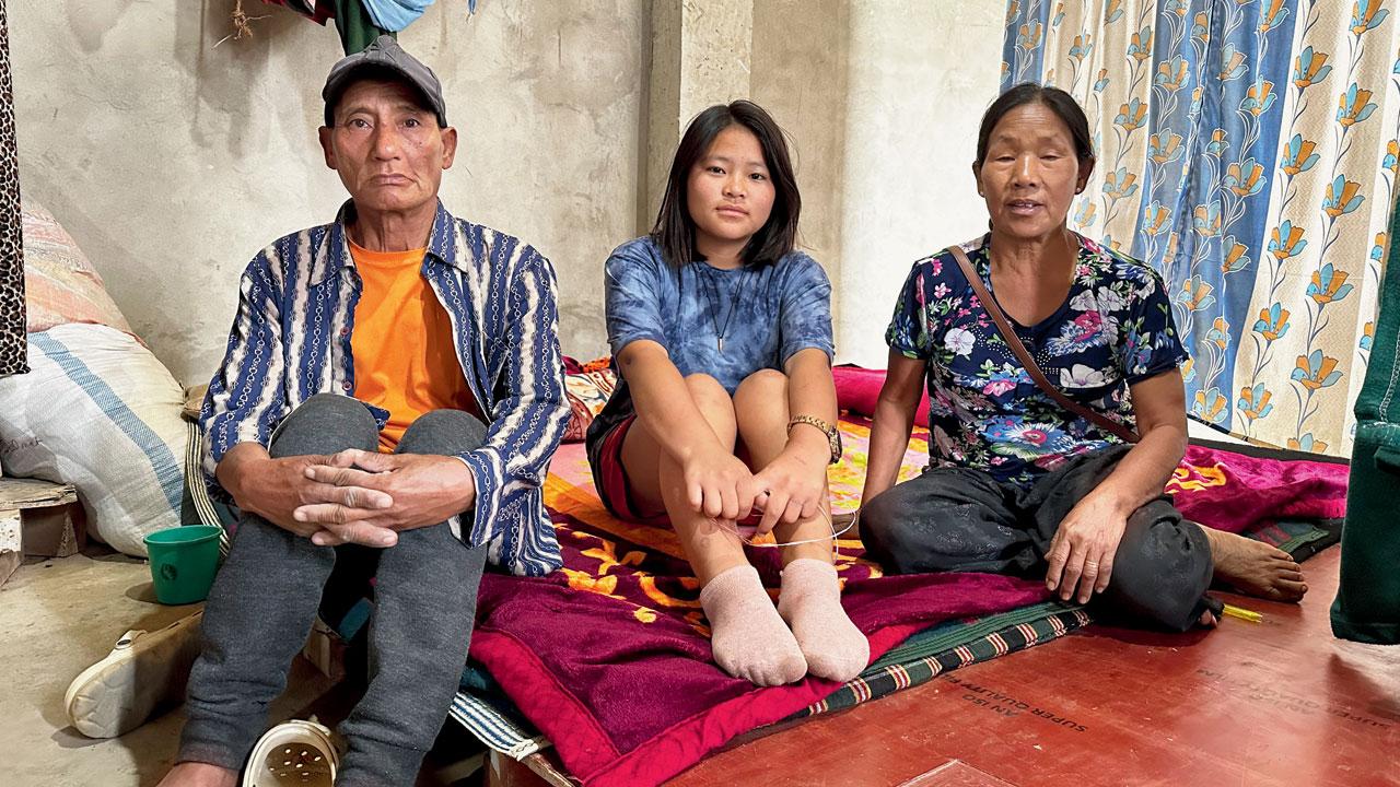 Nengchin and Paokam with their daughter live in a the under-construction Sangai University building. They have moved between three relief camps since their home was burned down last May