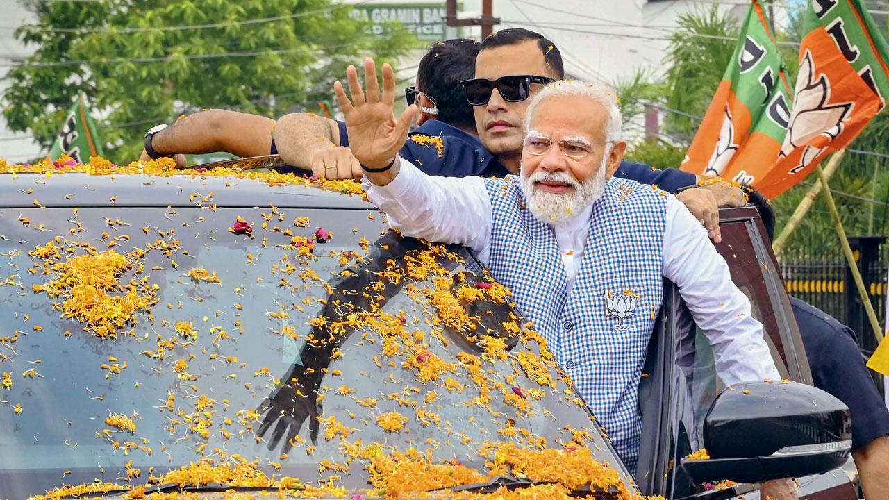 Prime Minister Narendra Modi waves to supporters. Pic/X