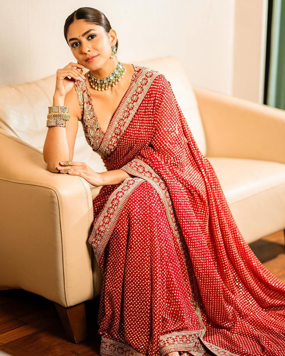 One can never go wrong with red, especially in ethnic wear. In this look, Mrunal wore a bright red saree with a beautiful golden border and stylish polka-dotted prints all over the six-yard