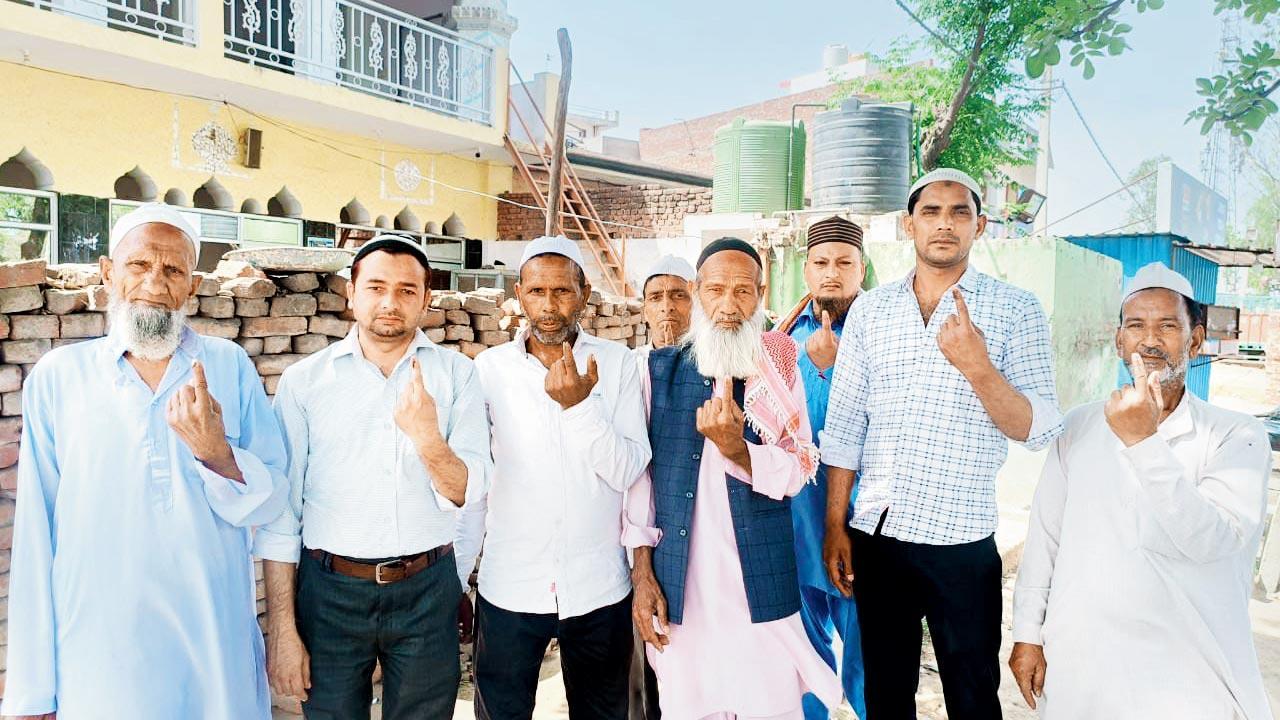Eshan Ali (second from left), a doctor from the Bhangeela village in Muzaffarnagar, along with other villagers