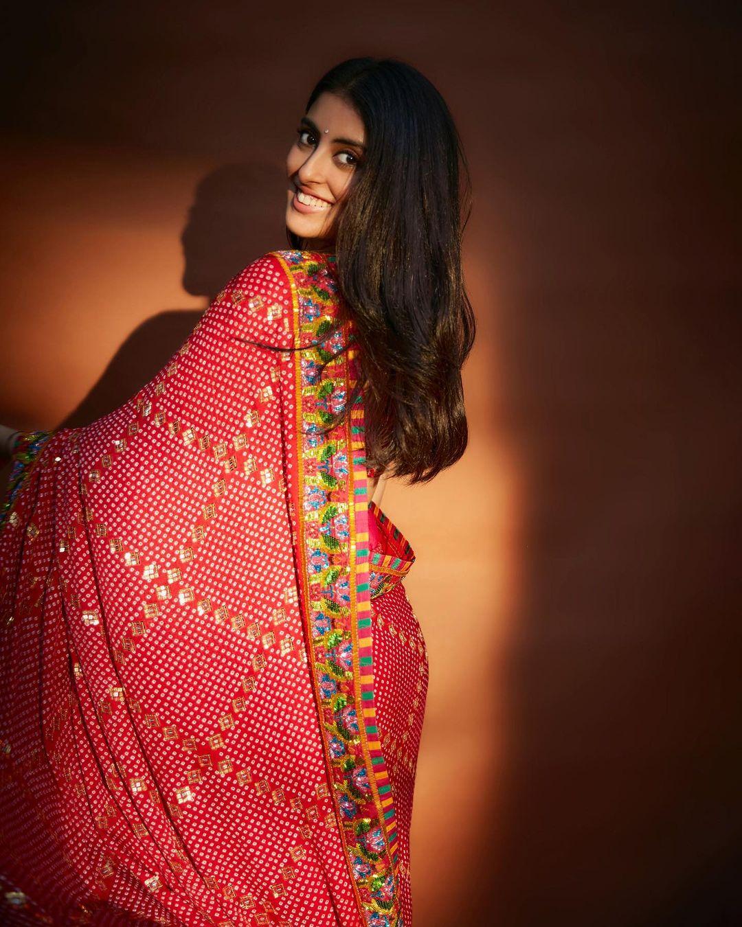 In this look, she wears a gorgeous heavily embroidered red saree and pairs it with a matching blouse. The saree's border showcases multiple colors, enhancing its look