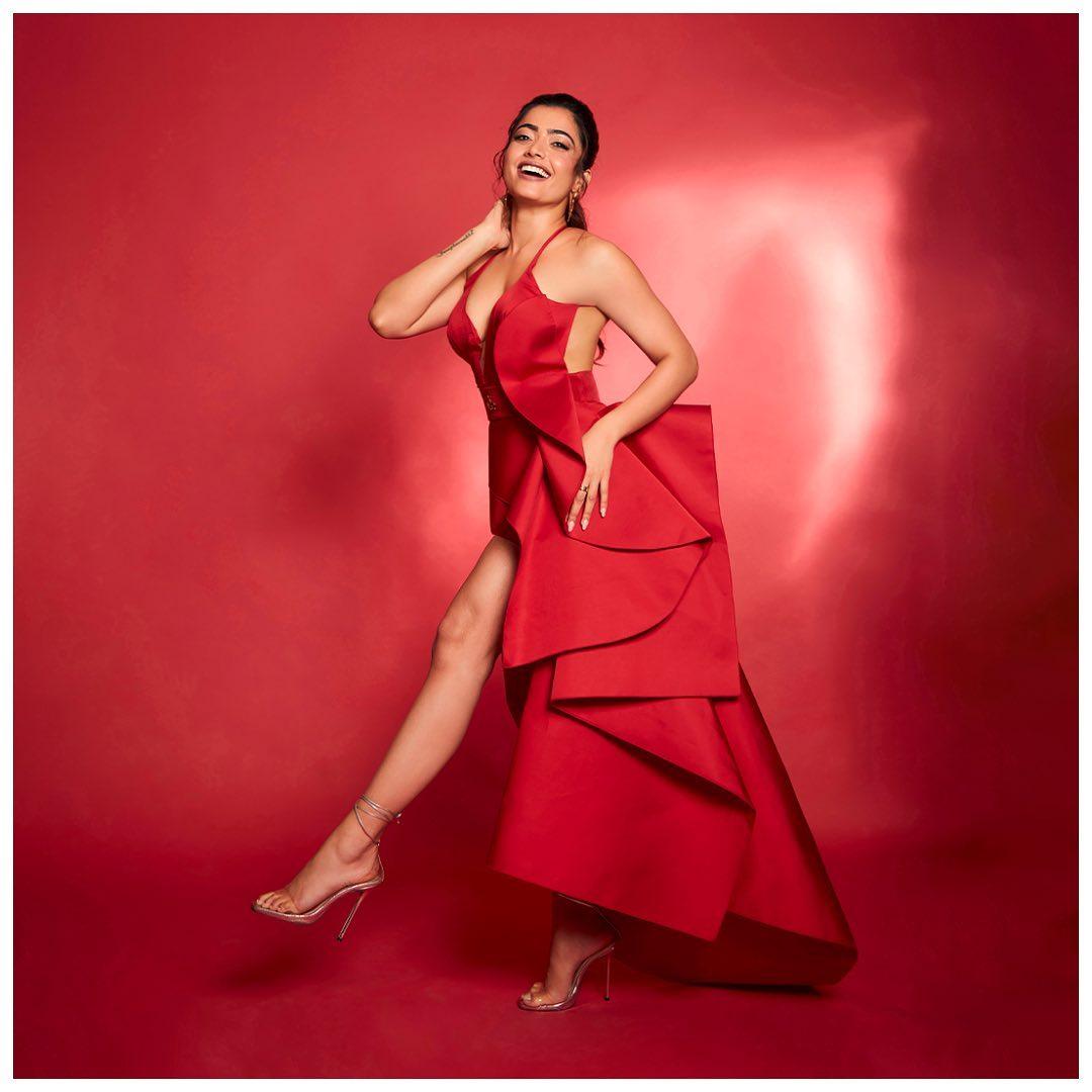  In this look, Rashmika wore a beautiful red dress with a long train. The outfit had a beautiful neckline