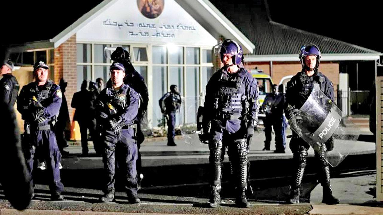 Security officers at Christ the Good Shepherd Church after the attack. Pic/AP