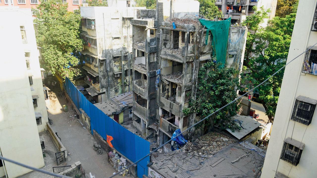 Mumbai: Slum dweller stands in way of dilapidated building’s demolition