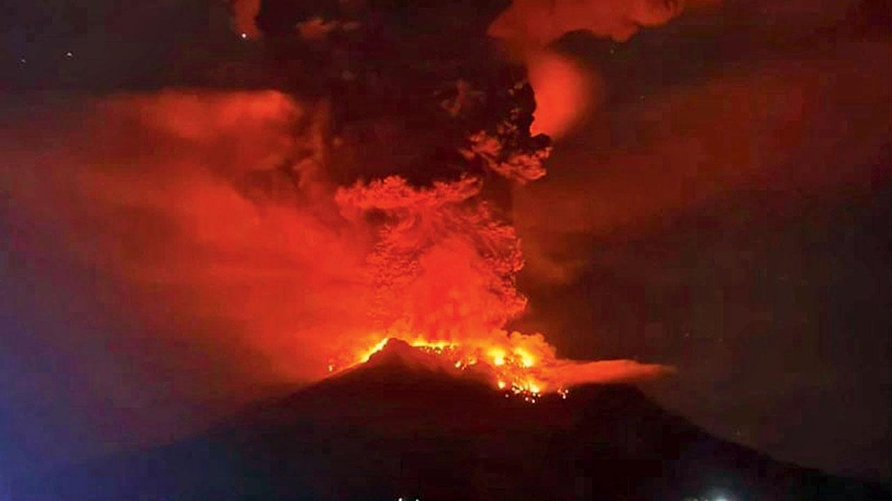Indonesians leave homes near erupting volcano, airport closed