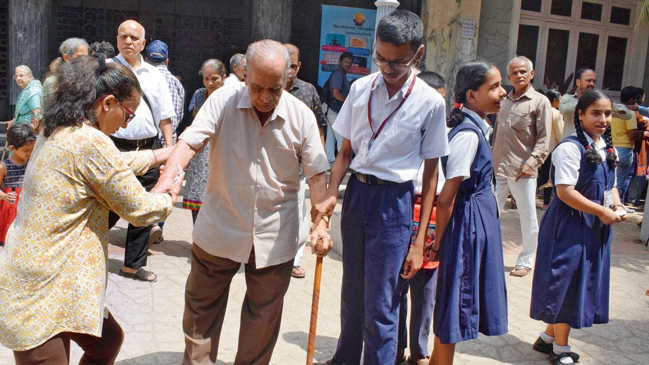 A youngster helping a senior citizen after voting. File Pic/Ashish Raje