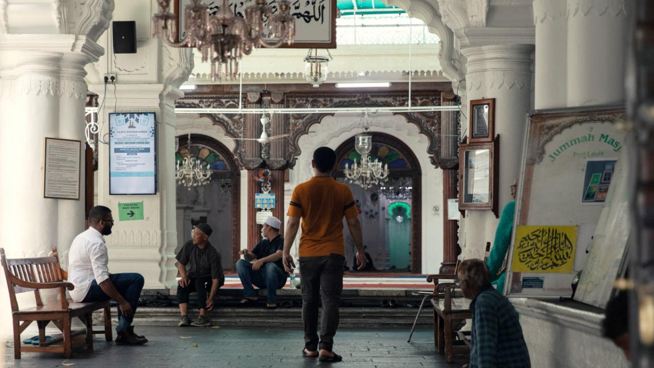 Muslim worshippers arrive at the Jummah Mosque ahead of the Friday prayers. The Jummah Mosque is a mosque in Port Louis, Mauritius dating from the 1850s. The building combines Indian, Creole and Islamic architecture