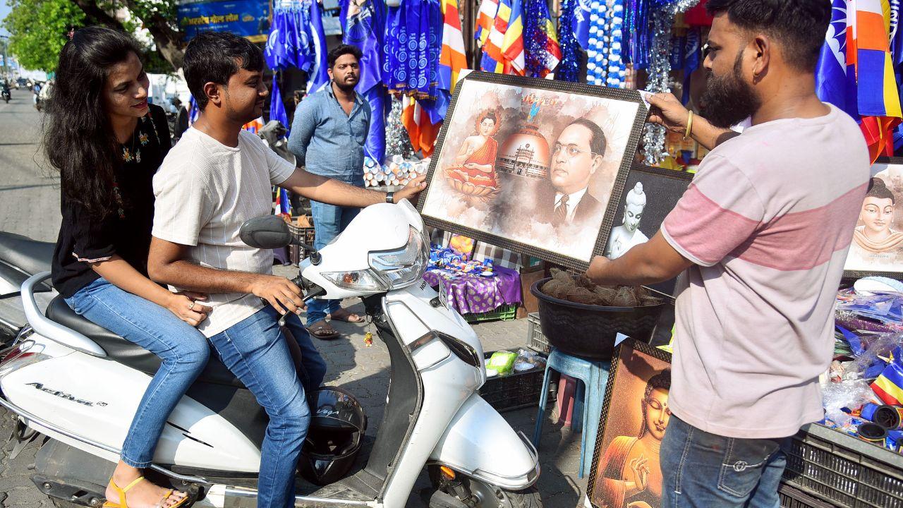 A man shows the portrait of Dr Bhimrao Ambedkar on the eve of his birth anniversary in Nagpur on Saturday. (ANI Photo)