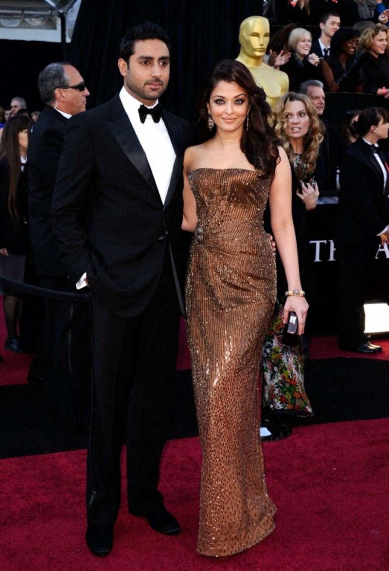 Aishwarya turned heads in a strapless shimmery copper gown as she and Abhishek posed at the 83rd Annual Academy Awards in 2011. 