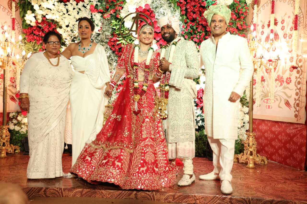 The newly weds strike a pose with Krushna and Kashmera as they step out to greet the paparazzi