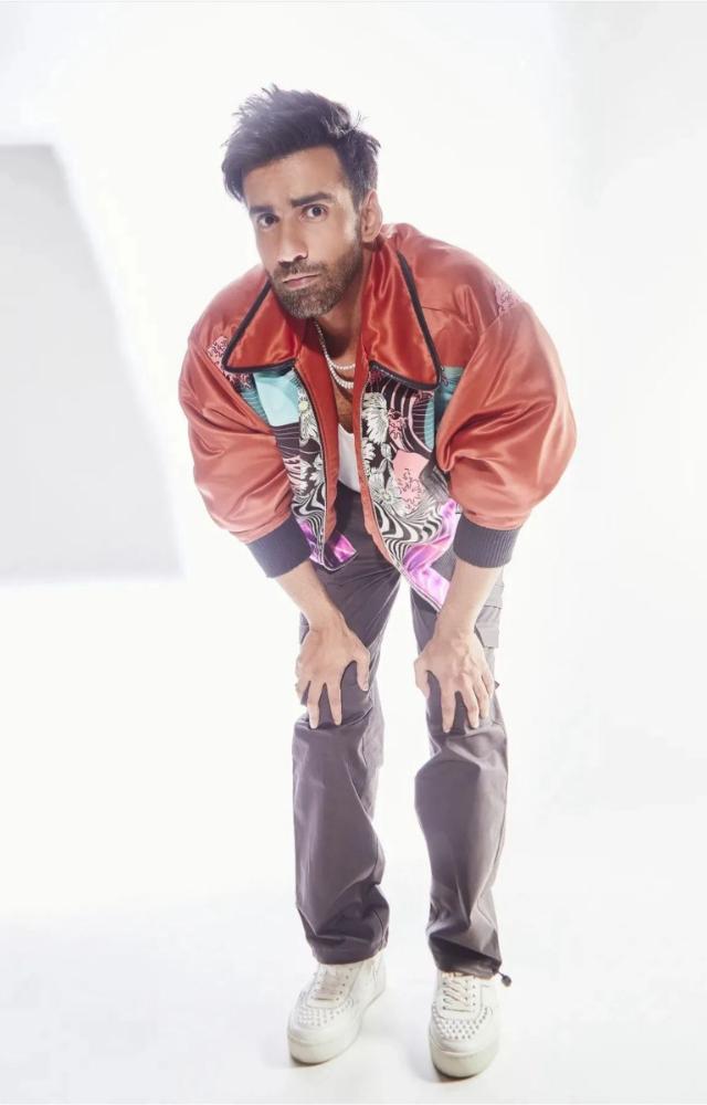 Channeling the cool dude vibe, Avinash rocks a graphic bomber jacket with grey cargos and a white vest. 