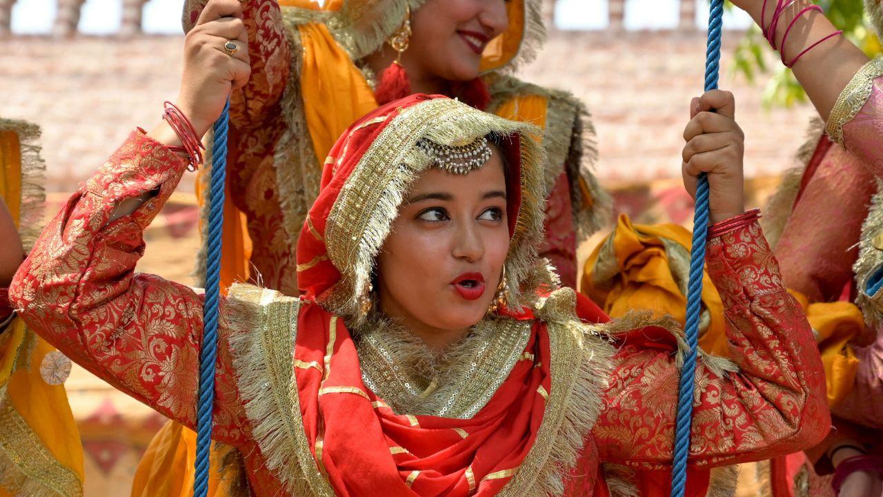 On the eve of Baisakhi, women from different regions of Punjab dressed up in traditional outfits to kickstart the festival celebrations. (Photo by Narinder NANU / AFP) 