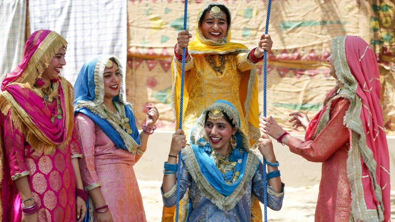 Women dress up in colourful traditional attire and jewellery and enjoy the swing during Baisakhi celebrations. (ANI Photo/Raminder Pal Singh)