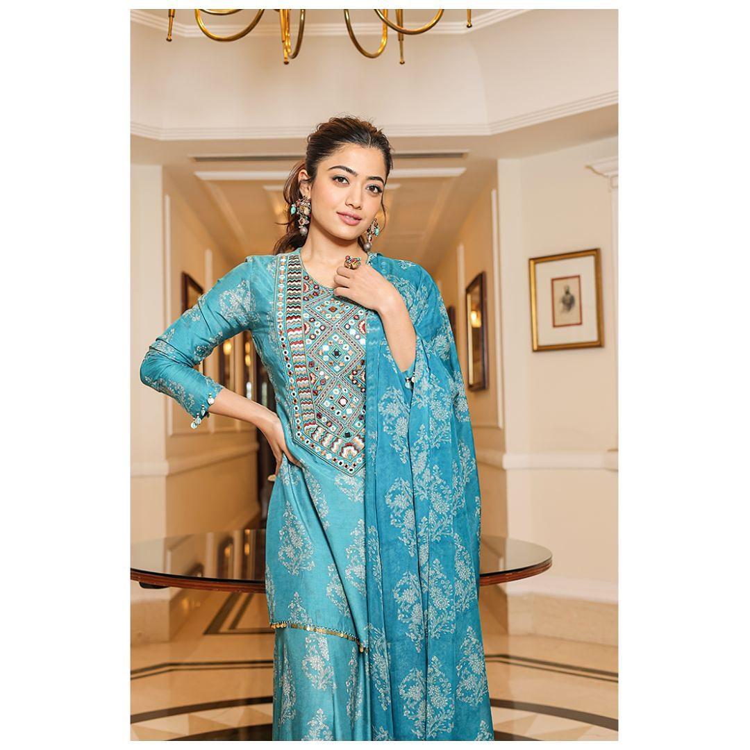 The set includes a three-quarter sleeved kurta, comfortable flared pants, and a matching dupatta. 