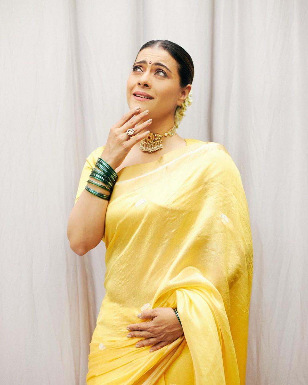 Kajol tied her hair up in a bun and decorated it with a gajra. To add to her look, she accessorized with green bangles and a choker necklace