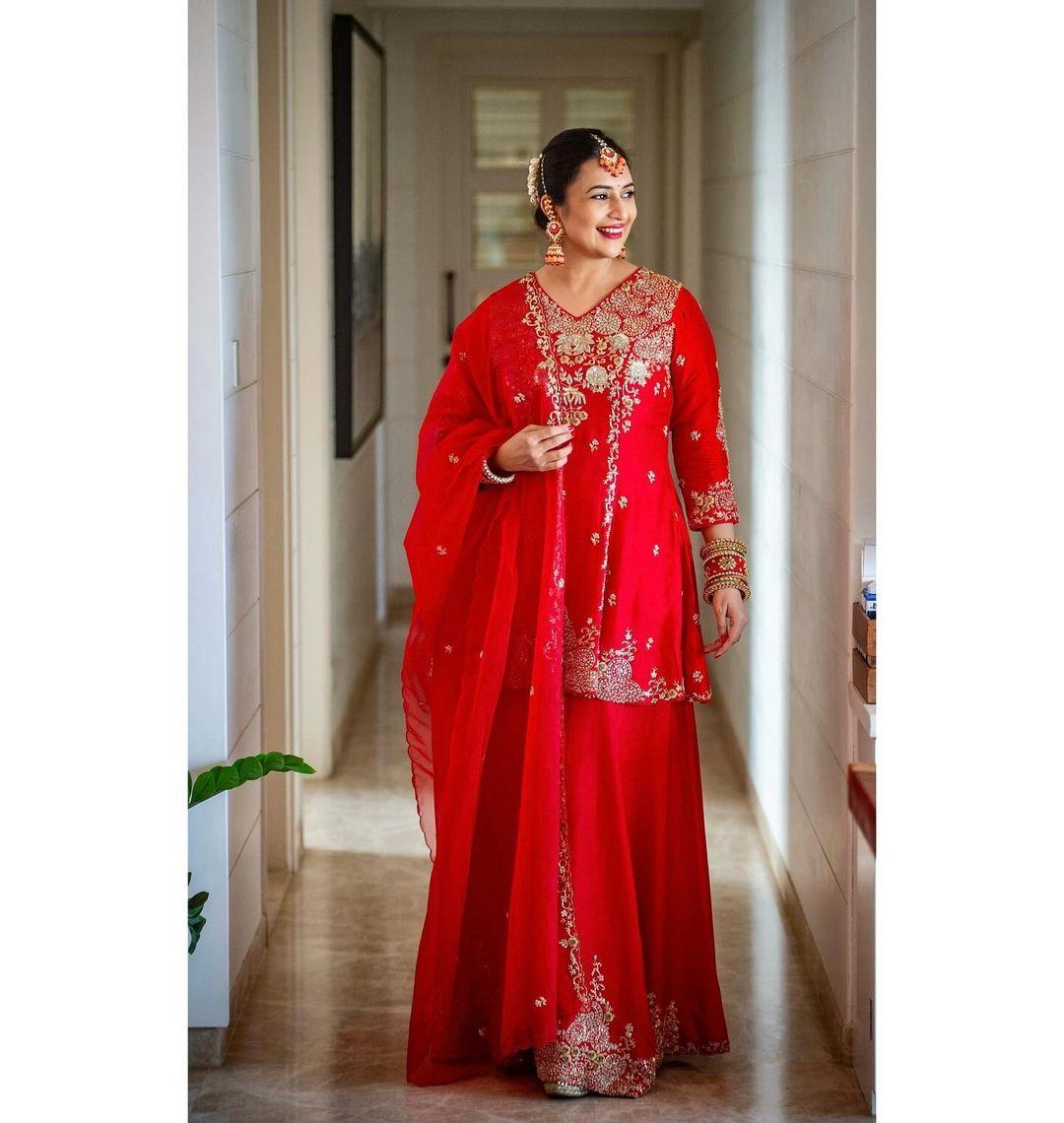 Divyanka Tripathi can ace any outfit, and her appearance in a red suit is proof. In this look, Divyanka wore a beautifully embroidered red suit paired with a matching long skirt and dupatta