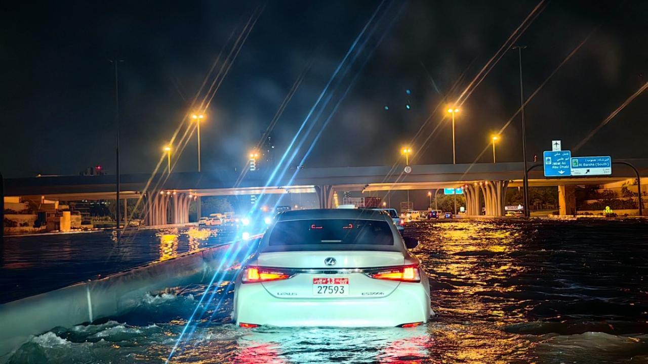 Cars drive in a flooded street following heavy rains in Dubai (Pic: AFP)