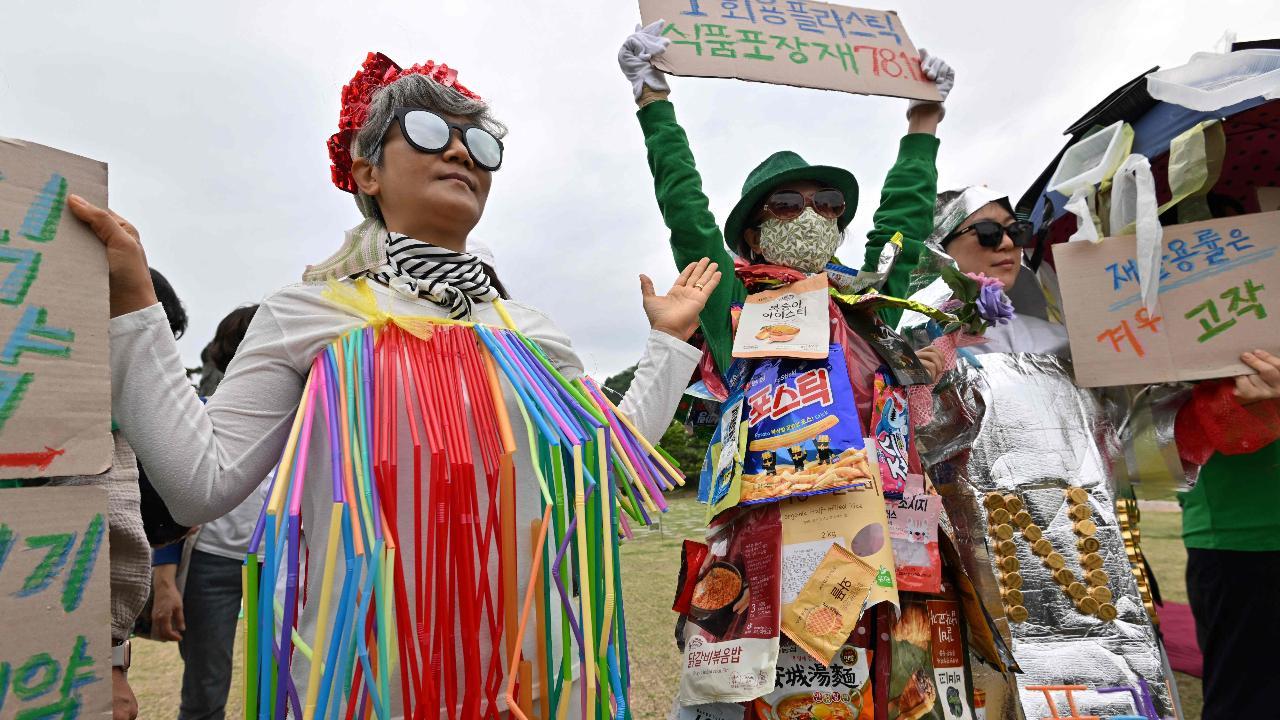Environmental activists wearing clothes made from plastic waste perform during a campaign event to mark the international Earth Day in Seoul (Photo by Jung Yeon-je/AFP)